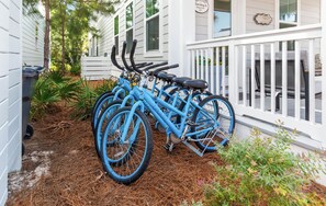 A row of blue bicycles parked outside a house with a white fence and a sign that says 'Welcome to Pinehurst.' - Pet Friendly 30A Resort Retreat Near Beach, Pool, The Big Chill, with LSV (Inlet Beach)