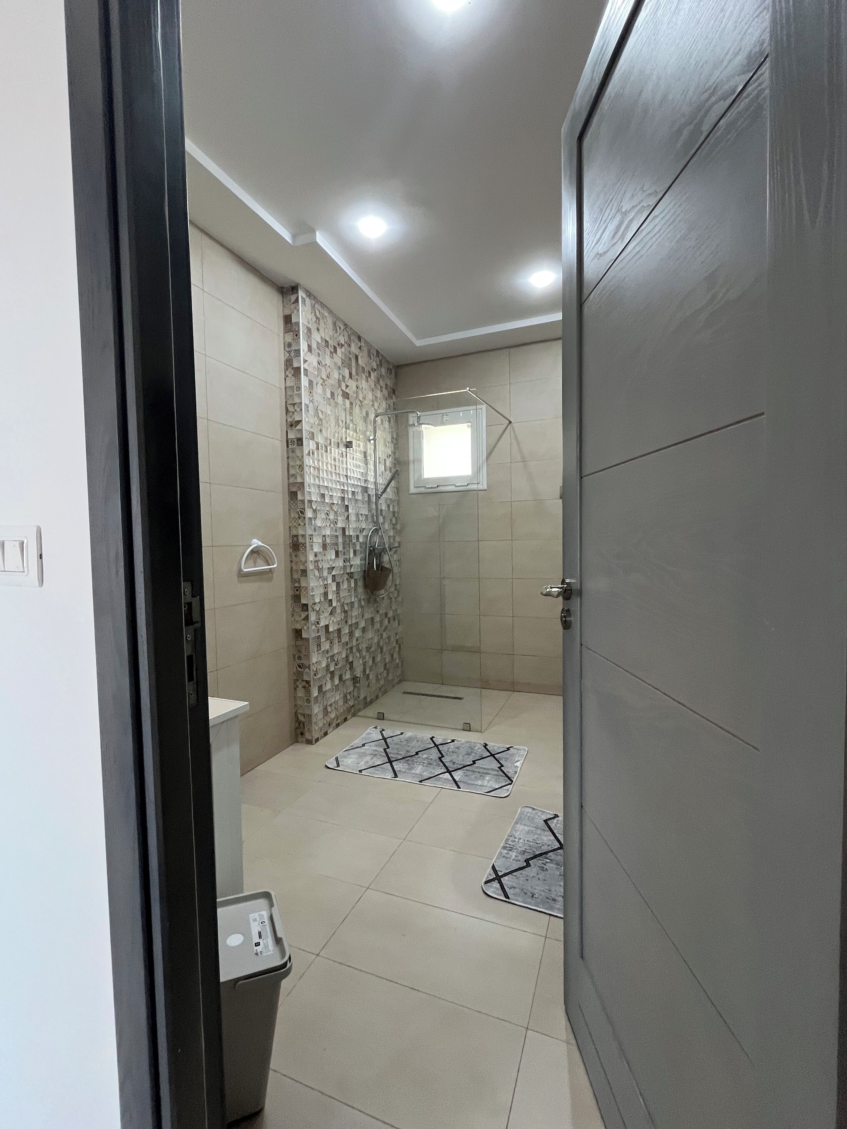 A bathroom with a shower, a toilet, and a sink.