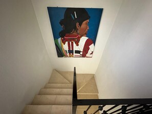A staircase with a painting on the wall. - SMALL HOUSE IN NUEVO VALLARTA WITH THREE BEDROOMS AND TWO BATHROOMS IN A QUIET NEIGHBORHOOD (Mezcales)