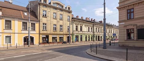 A street with buildings, a pedestrian crossing, and a clear sky.