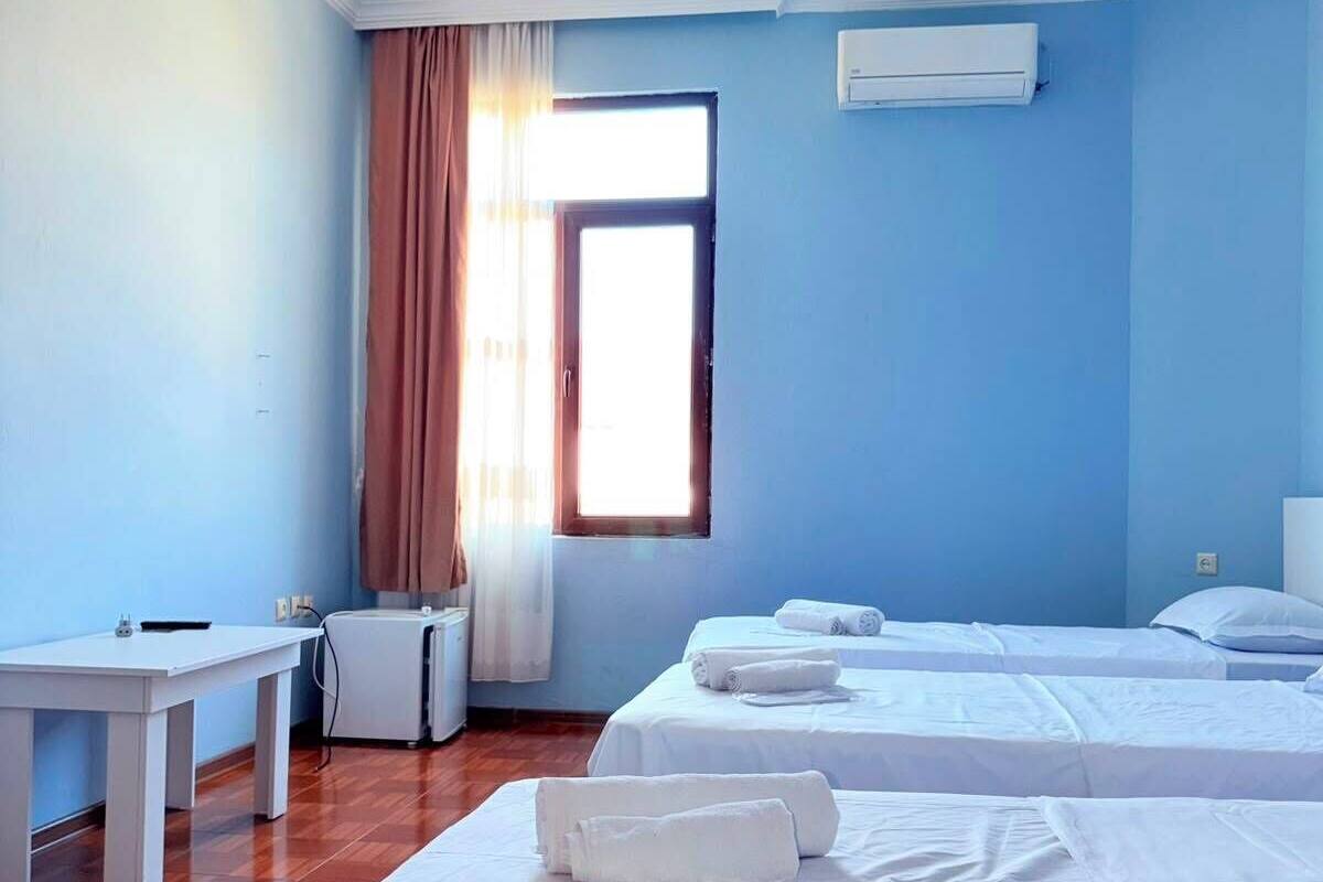 Family Triple Room, Balcony, Park View | In-room safe, desk, laptop workspace, blackout drapes