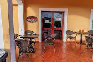 A cafe named 'El Coco' with outdoor seating and a tiled floor. - Luxury Pool Condo Near Beach & Downtown (Punta Cana)