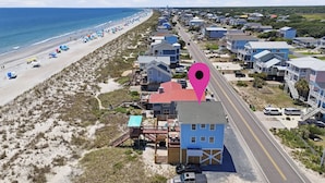 A coastal residential area with beach access, houses, and a road. - Dune Life at OKI: Oceanfront with Pool (Oak Island)