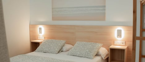 A neatly arranged bedroom with a bed, two bedside tables, and a wall-mounted light fixture.