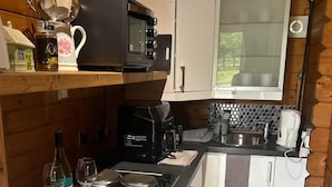 A compact kitchen with a microwave, coffee maker, and a small refrigerator. - Gortin Glen Forest Cabin, Sleeps 7 With Parking (Omagh)