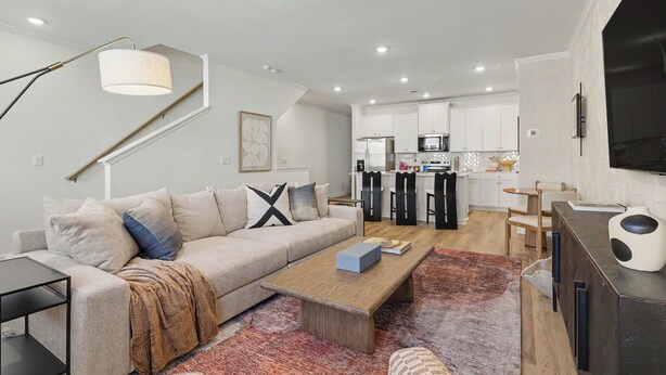 A modern living room with a sofa, coffee table, and a TV stand. - Grant & Groove: Where timeless design meets the rhythm of ATL. (Atlanta)