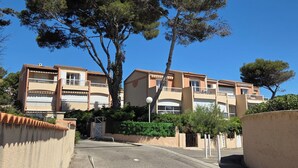 A residential building with multiple balconies, a gated entrance, and surrounding greenery. - In the heart of the Calanque du Cap Rousset—Apartment with a sea view, perfect for a romantic getaway! (Carry-le-Rouet)