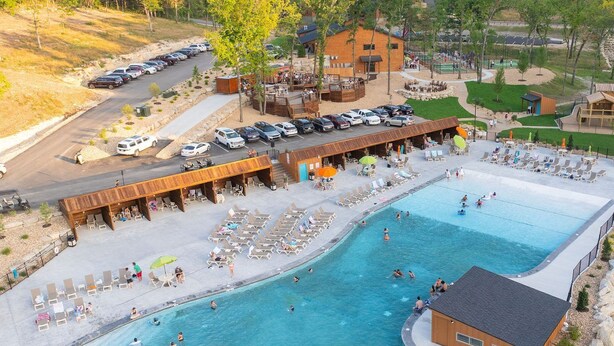 A resort with a large swimming pool, a covered seating area, and a parking lot. - NewCabin, Pools, Lazy River, Private HotTub, Firepit, near Branson, BigCedar (Hollister)