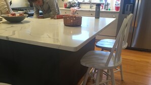 A kitchen island with a bowl of fruit, a basket, and a water bottle. - Ocean Block.  Amazing 5-bedroom house with AC in charming Spring Lake! (Spring Lake)