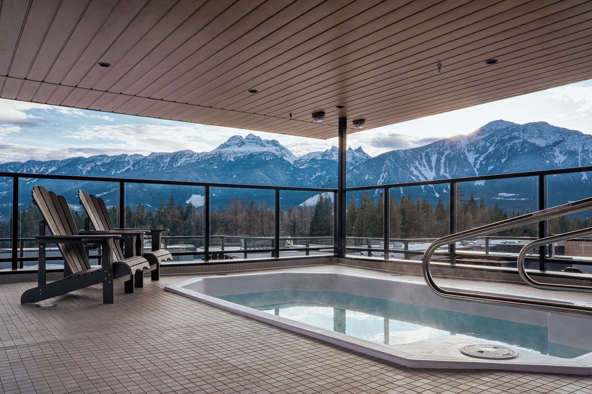 A hot tub with a view of snow-capped mountains.