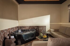 A spa area with a hot tub, seating, and a small table with fruits.
