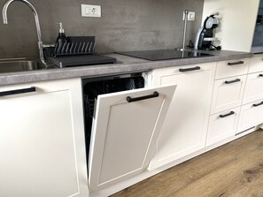 A kitchen with a stainless steel sink, a dishwasher, and a coffee machine. - BLED LAKE HOUSE - Apartment Castle (Bled)