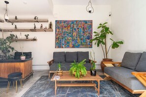Ein modernes Wohnzimmer mit einer Couch, einem Couchtisch und Zimmerpflanzen.