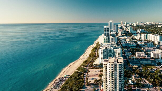 A coastal cityscape with high-rise buildings, a beach, and a clear sky. - ADA Queen Studio w/ Tub | Free Breakfast! (Miami)