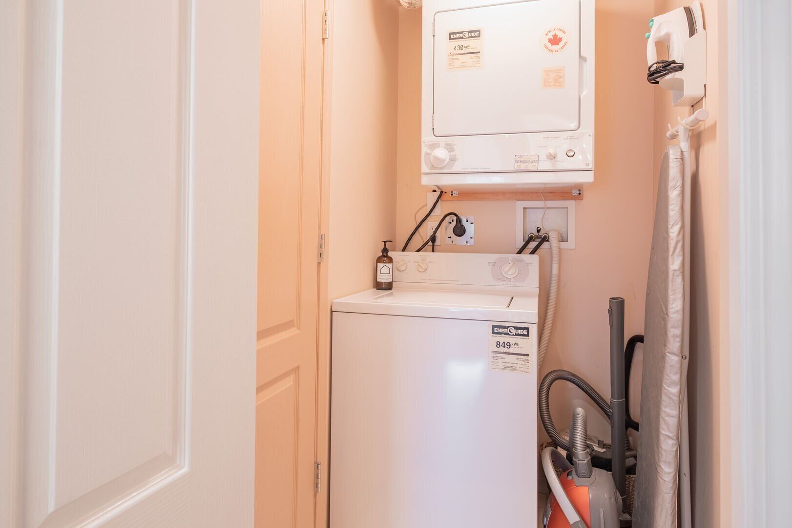 A laundry area with a washing machine, a dryer, and a water heater.