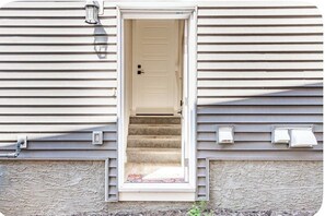 A house with a door leading to a carpeted staircase. - Cozy & Stylish 1-Bedroom Suite Perfect for Couples or Solo Travellers (Calgary)