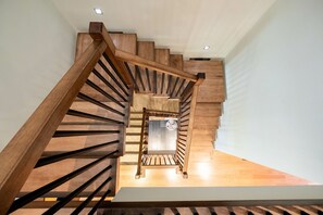 A wooden staircase with a modern design, leading to an upper floor. - Luxury | AC | Private Hot Tub | BBQ | Pet friendly (Whistler)