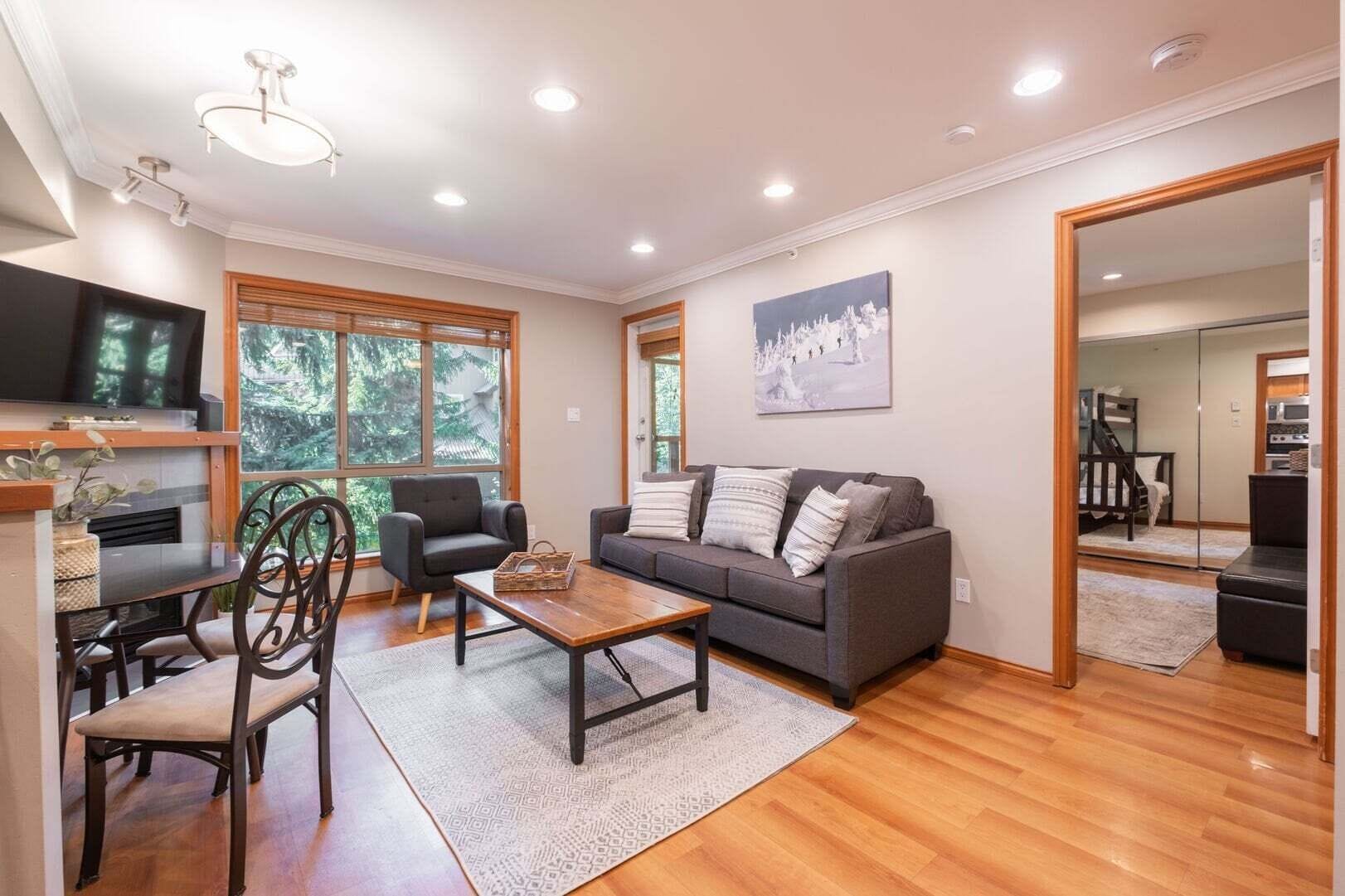 A modern living room with a sofa, coffee table, and TV.