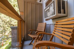 A wooden bench and a window with an air conditioning unit. - Great location | Hot tub, pool & sauna | BBQ | AC (Whistler)