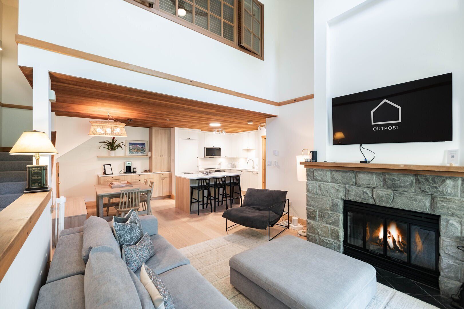 A modern interior with a living room, kitchen, and dining area.