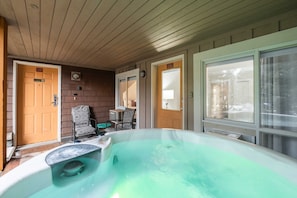A room with a hot tub, two doors, and a window. - Excellent location | Private hot tub | Pets | BBQ (Whistler)