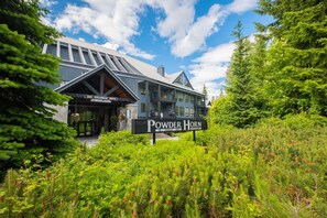 A lodge named Powder Horn at 4821 Spearhead Drive, surrounded by lush greenery and trees. - Walk to Blackcomb | Complex hot tub | BBQ (Whistler)
