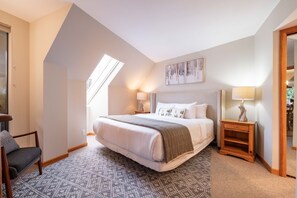 A bedroom with a large bed, a desk, a chair, and a window. - Penthouse, Mountain Views, Ski-In/Out, Pool, Hot Tub, Gym (Whistler)