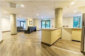 A spacious lobby with a reception desk, seating area, and large windows. - Penthouse, Mountain Views, Ski-In/Out, Pool, Hot Tub, Gym (Whistler)