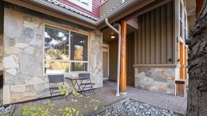 A stone exterior with a patio, outdoor seating, and a stone pathway. - Great location | Complex hot tub | BBQ | Pets (Whistler)