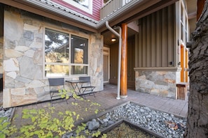 A stone exterior with a patio, outdoor seating, and a stone pathway. - Great location | Complex hot tub | BBQ | Pets (Whistler)