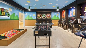 A room with a foosball table, colorful ball pit, and gaming consoles. - Resort Amenities Included! 7 BD/ 6 BA/ Storey Lake 4585 TB (Kissimmee)