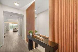 A modern interior with a reception desk, wooden paneling, and a view to a balcony. - 6 BD/ 5 BA/ Solara Resort (9038 SR) (Kissimmee)