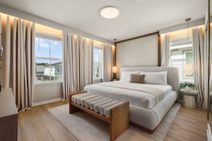 A modern bedroom with a large bed, bedside tables, a nightstand, a bench, and a view of the outside. - Immersive Rooms 9 BD/7 BA/Windsor Cay - 16054 CC (Clermont)