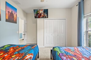 A bedroom with two beds, a white door, and a ceiling fan. - 5 BD/ 4 BA/ Storey Lake (4823 BR) (Kissimmee)