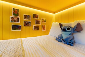 A room with a bed, a plush toy, and framed pictures on the wall. - 7 BD / 5.5 BA / Windsor Cay 16115 CC (Clermont)