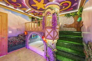 A child's playroom with a bunk bed, a slide, and a wall mural. - Magical Rooms & Game Zone 5 BD/ 4.5 BA/ Windsor Cay - 16214 CC (Clermont)