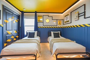 Quarto com duas camas, uma janela e avisos de segurança na parede.