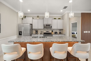 A modern kitchen with granite countertops, stainless steel appliances, and pendant lighting. - Luxury 6BD/4.5BA Windsor Island (3763 La) (Davenport)