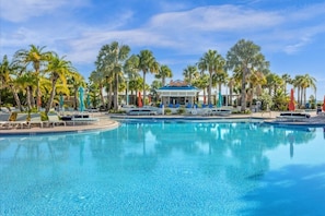 A large swimming pool with lounge chairs and palm trees. - 6 BD/ 4.5 BA/ Windsor Island (3763 LA) (Davenport)