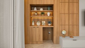 A wooden cabinet with shelves containing decorative items and a globe on top. - 7 BD/ 5.5 BA/ Windsor Cay (1095 OP) (Clermont)