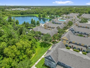 A residential area with multiple two-story houses, a lake, and a swimming pool. - Family Comfort House / Sleeps 6  - 31-106 (Kissimmee)