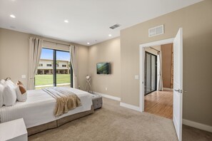 A bedroom with a bed, a window, a door, and a view of a building outside. - 4 BD/ 4.5 BA/ Magic Village Views (7478 BD) (Kissimmee)