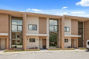 A modern multi-story building with large windows and a flat roof. - 4 BD/ 4.5 BA/ Magic Village Views (7478 BD) (Kissimmee)