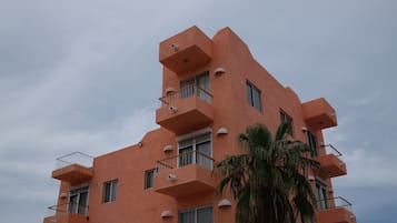 A multi-story building with balconies and windows.