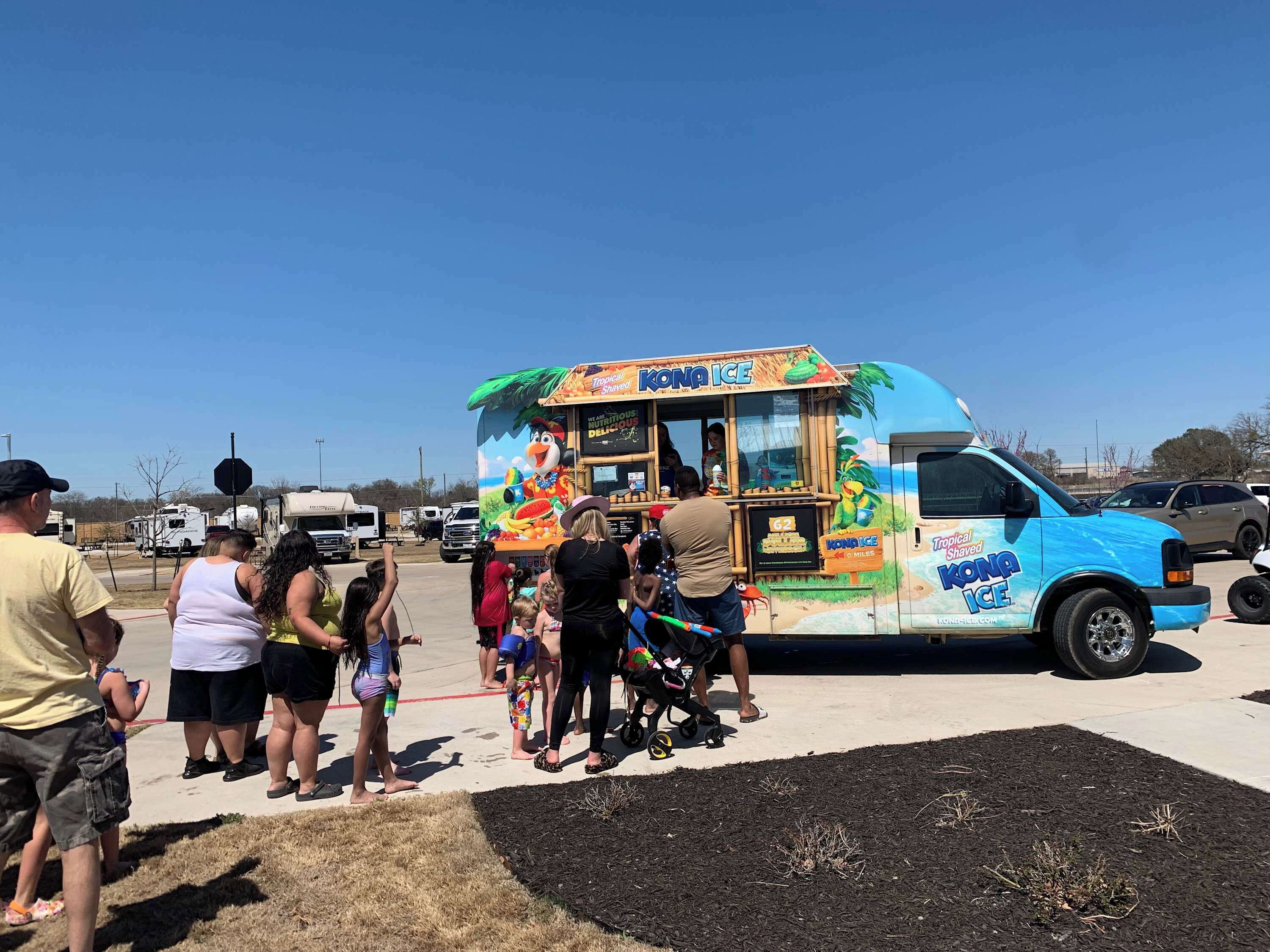 A food truck with tropical-themed branding and a menu display.