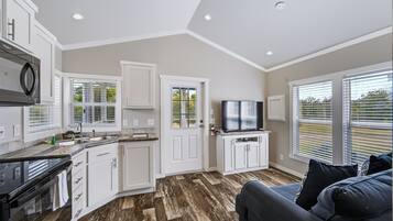 The open concept living space makes it easy to cook, dine, and relax together in your cozy home away from home.