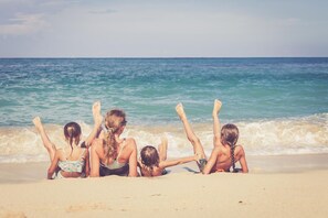 A group of people sitting on a sandy beach with the ocean in the background. - Great 8 berth caravan at Steeple Bay in Essex ref 36091F (Southminster)