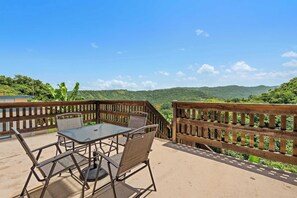 An outdoor patio with a table and chairs, overlooking a mountainous landscape. - Casa Verde at Hacienda Serena w/ Mt. View + River (Las Marías)