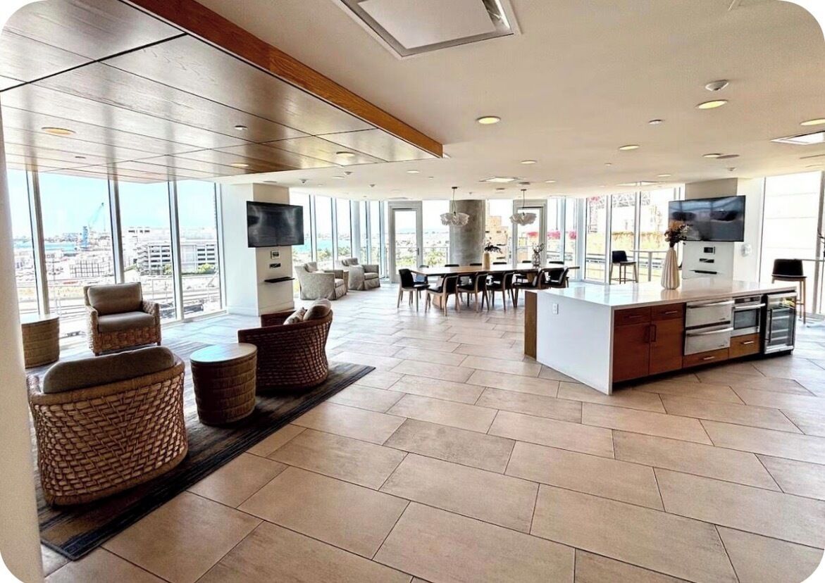 A spacious living area with a kitchen, dining table, and comfortable seating.