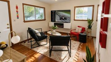 Living room with fireplace, TV, and seating
